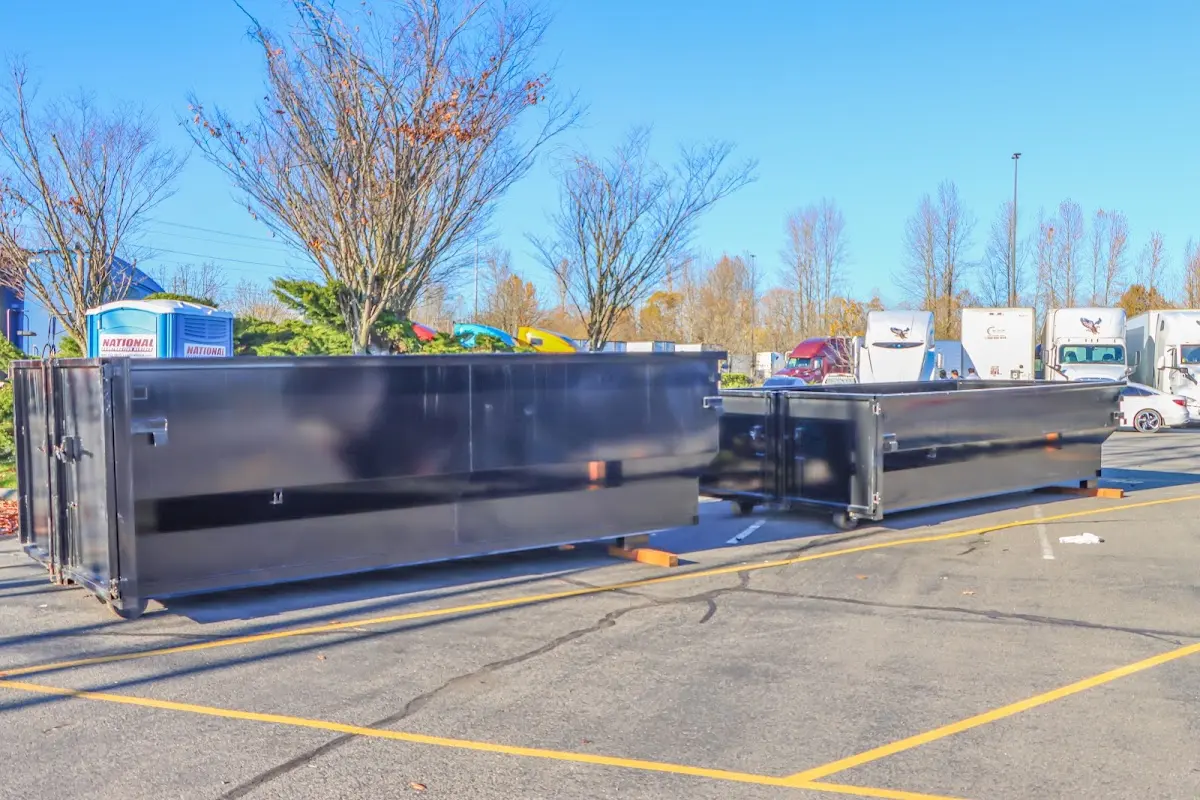 Professional dumpster rental service with roll-off container on residential driveway in Midway